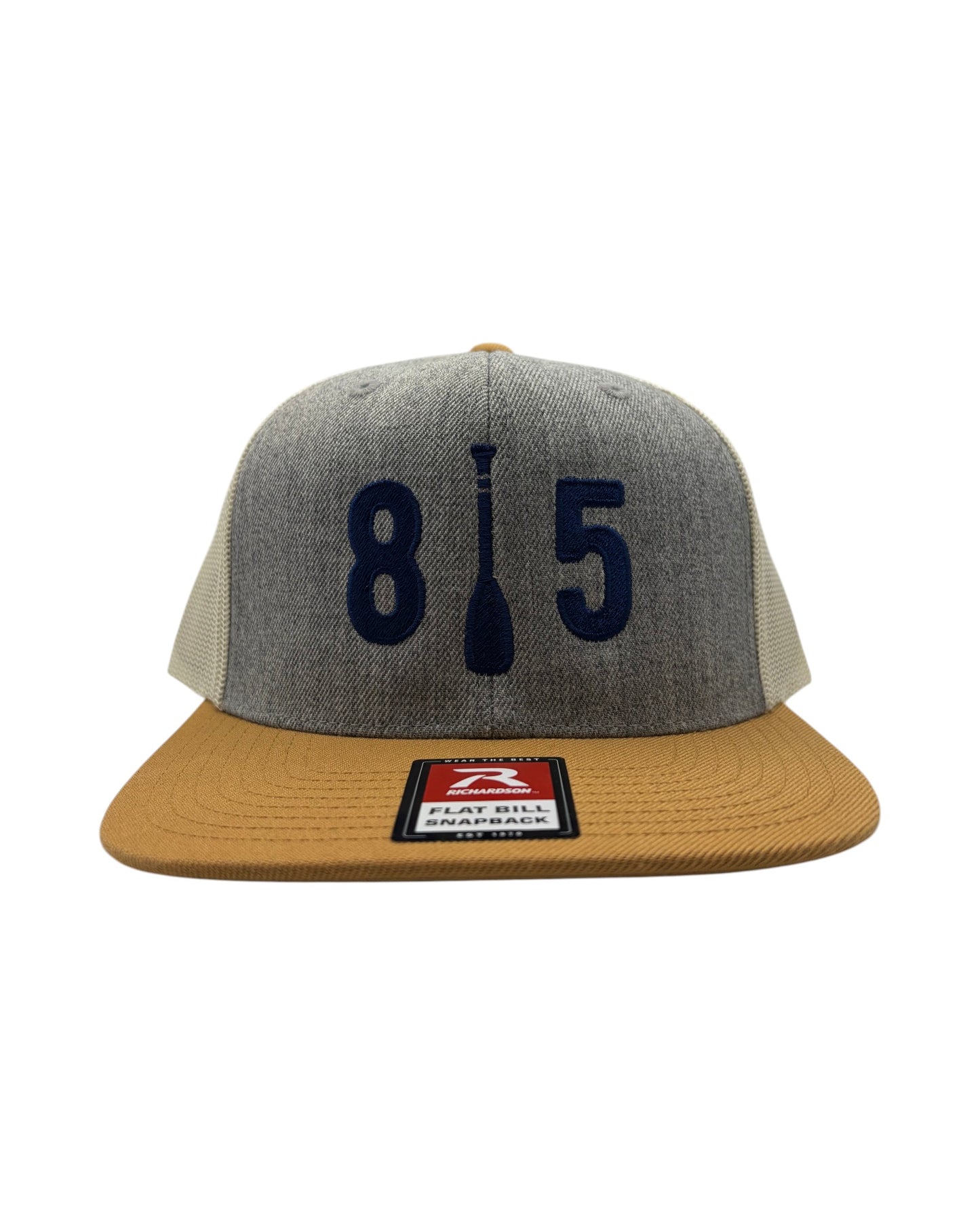 Blink Supply Co grey trucker cap with tan bill and navy blue 815 paddle logo embroidery. Six-panel, low-profile snapback.