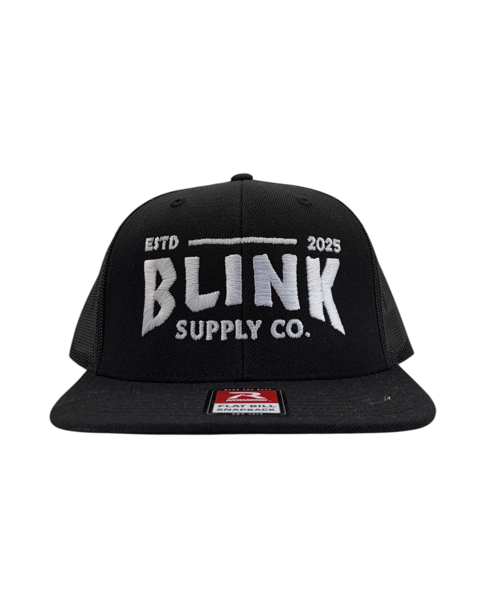 Blink Supply Co. black trucker hat with embroidered logo and flat bill. Features a snapback closure and mesh back panels.