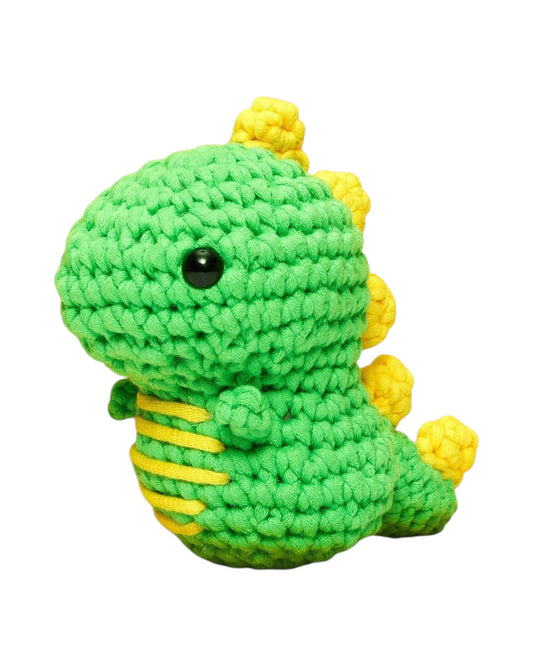 Blink Supply Co Fred the Dinosaur beginner crochet kit, green with yellow accents and black eyes.