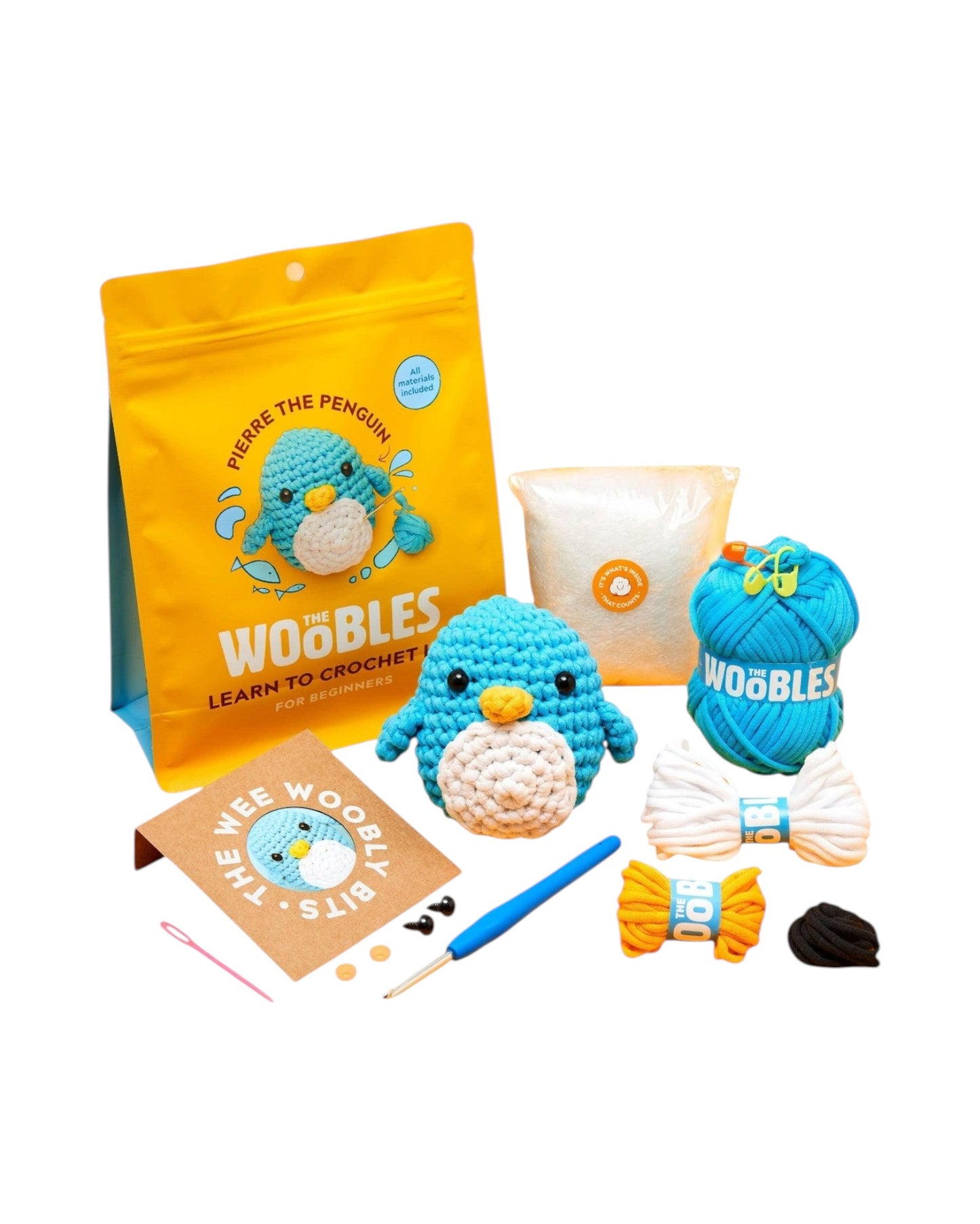 Blink Supply Co Pierre the Penguin beginner crochet kit with blue yarn, stuffing, and tools.